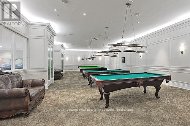 A room with a pool table and a couch.