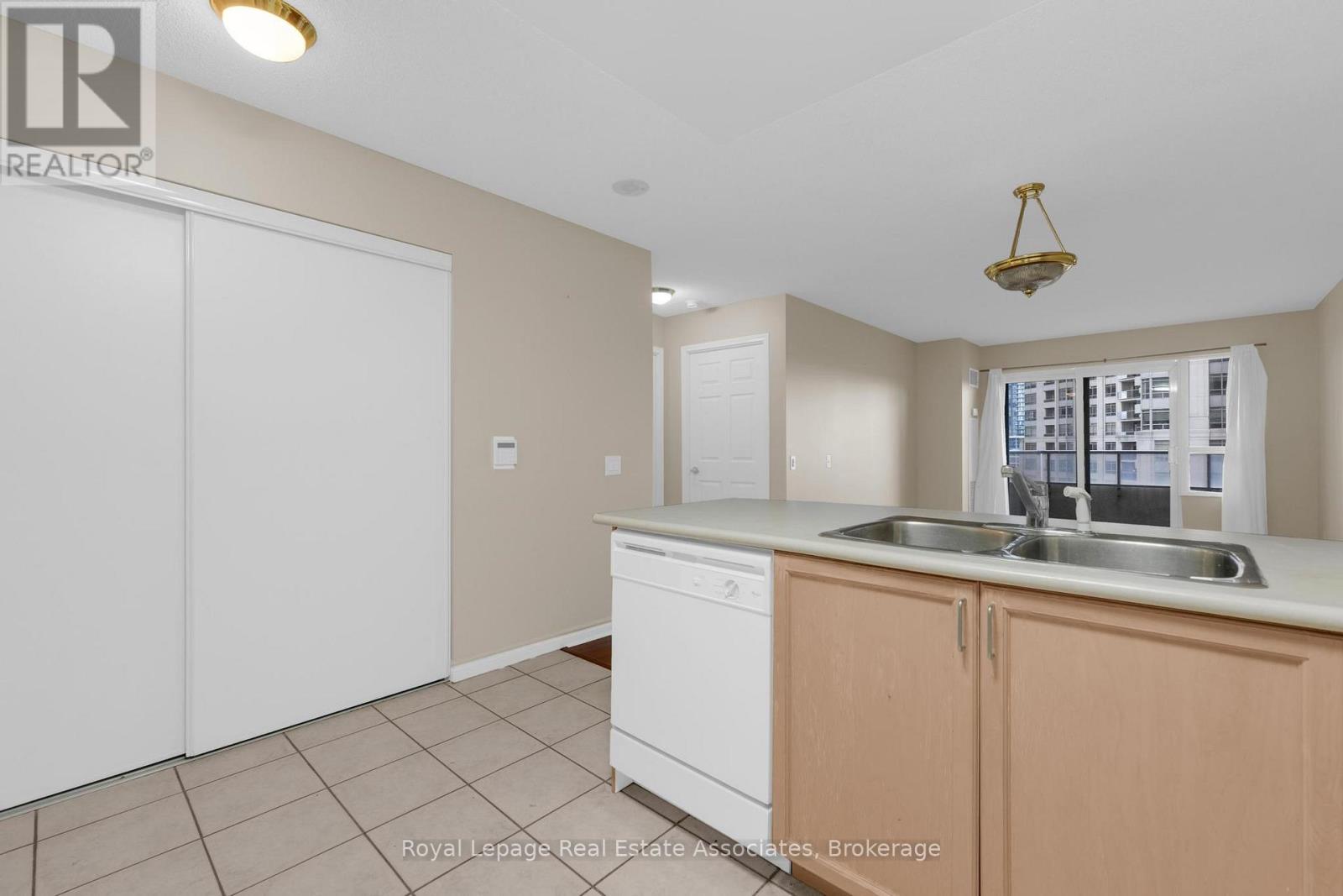 A kitchen with white cabinets and a sink.