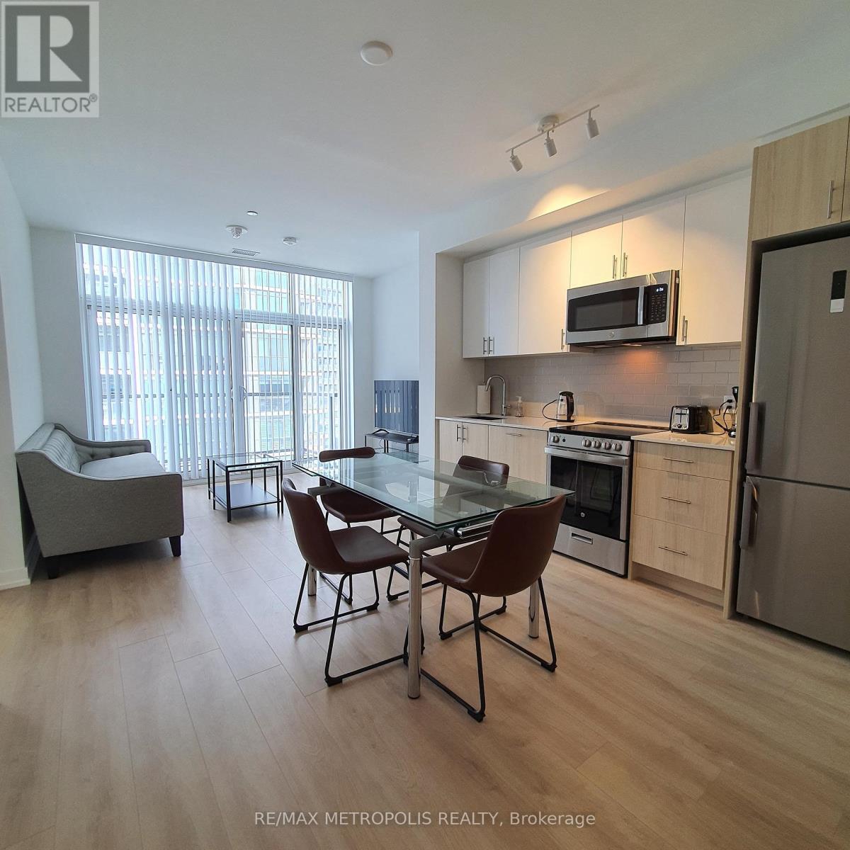 A modern kitchen with a dining table and chairs.