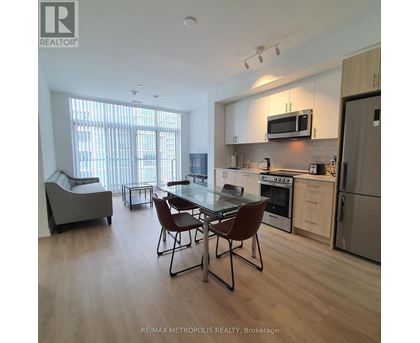 A modern kitchen with a dining table and chairs.