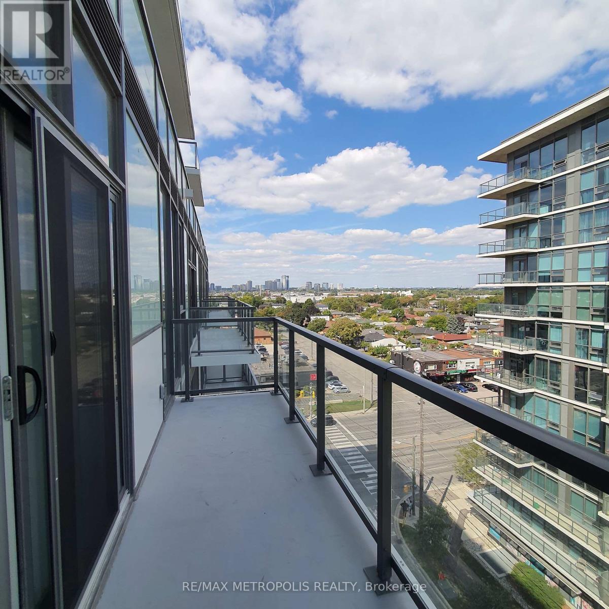 A balcony of a building with a view of the cityscape.