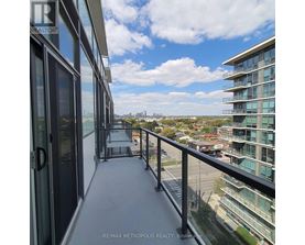 A balcony of a building with a view of the cityscape.