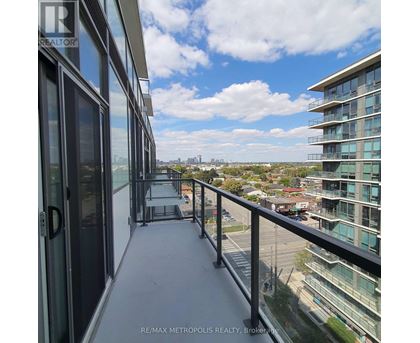 A balcony of a building with a view of the cityscape.
