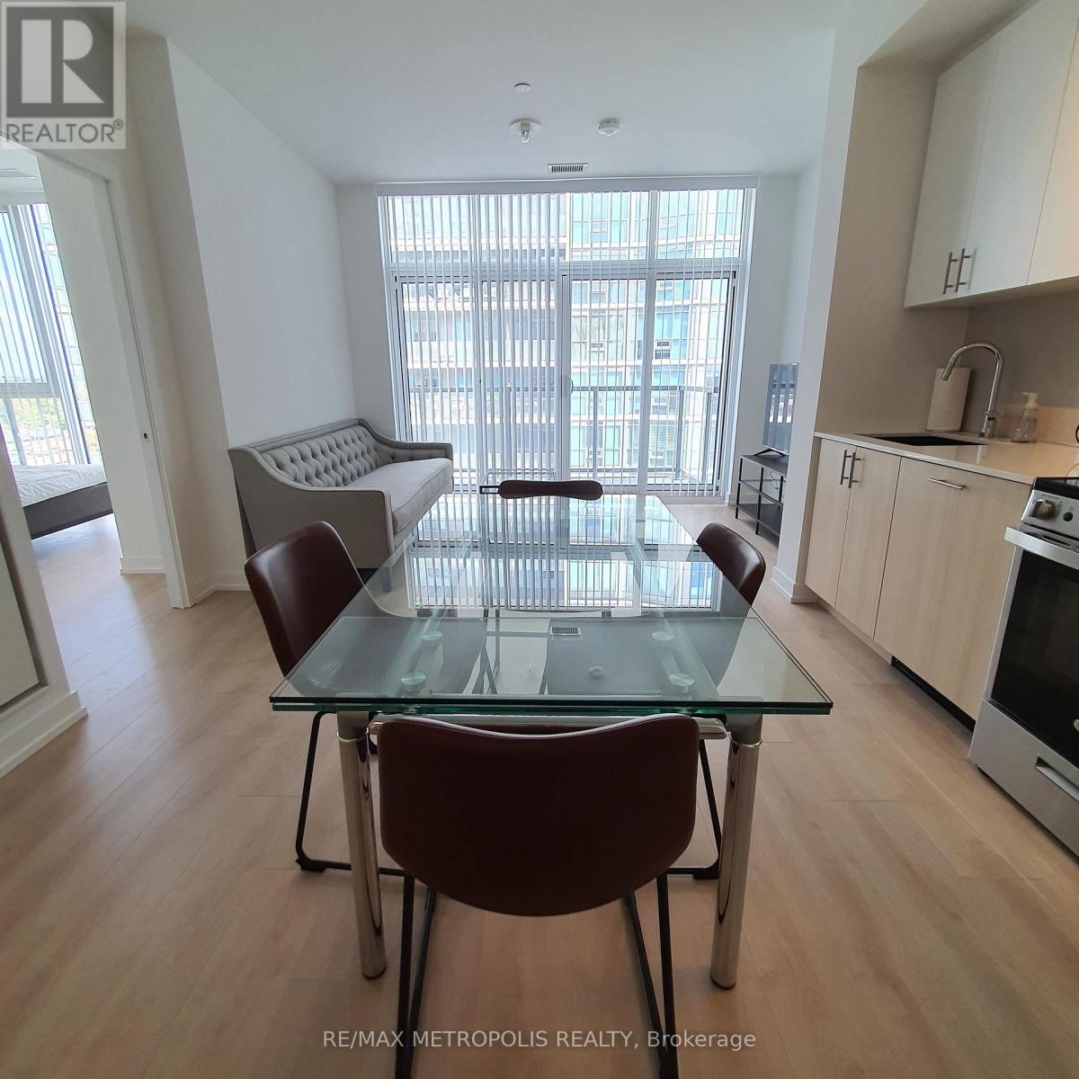 A dining room with a glass table and chairs.