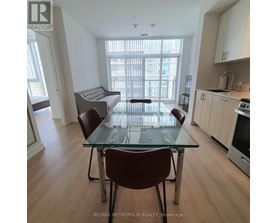 A dining room with a glass table and chairs.
