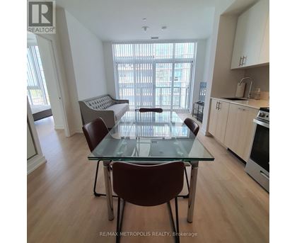 A dining room with a glass table and chairs.