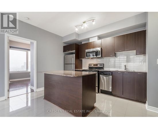A kitchen with a brown counter and stainless steel appliances.