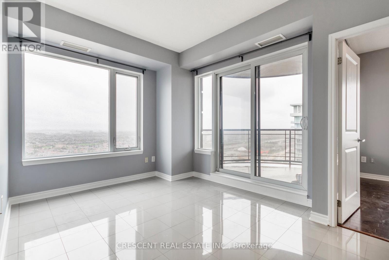 A spacious room with large windows and a view of the outside.