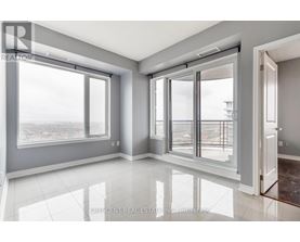 A spacious room with large windows and a view of the outside.