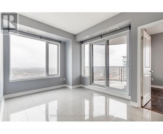 A spacious room with large windows and a view of the outside.