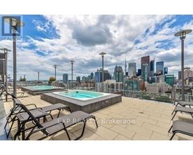A rooftop with a pool and chairs overlooking a city skyline.