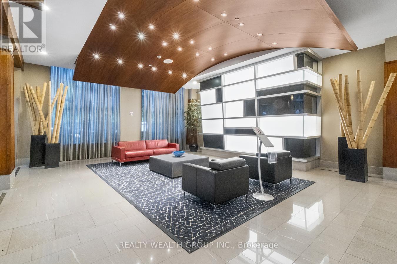 A modern living room with a red couch and a wooden ceiling.