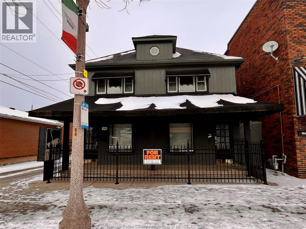 A house with a "For Sale" sign in front of it.