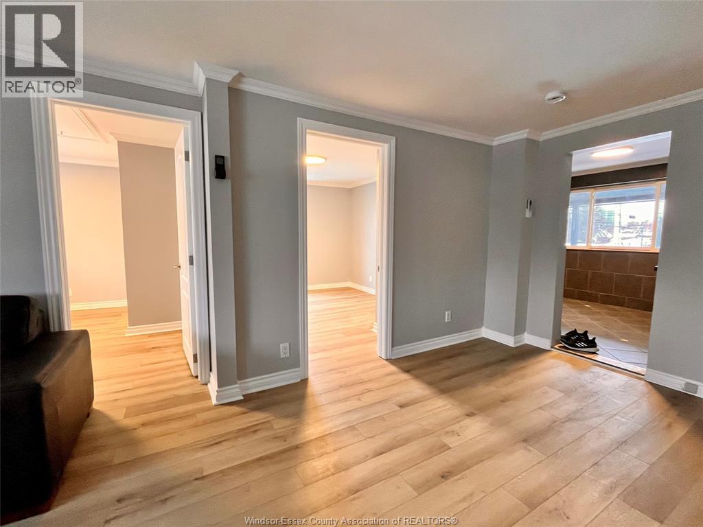 A room with wooden floors and a pair of shoes on the floor.