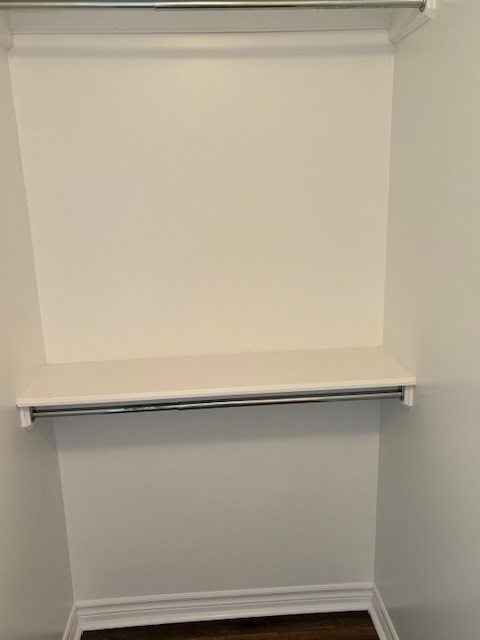 A white shelf is mounted on a white wall.