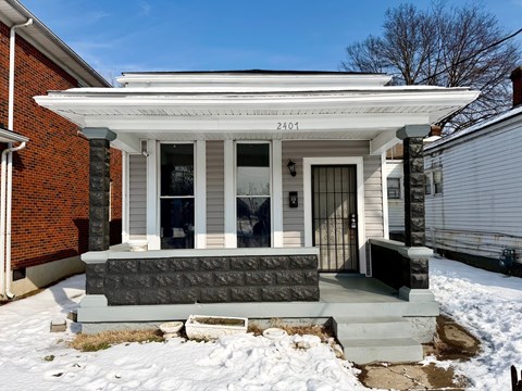 A house with the number 2401 on the front porch.