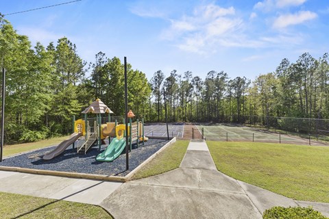 A playground with a green slide and a yellow slide.