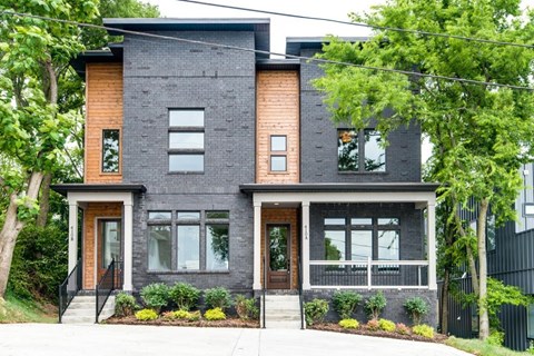 A modern house with a black and brown exterior.