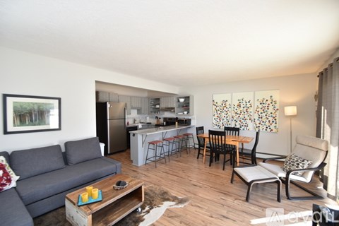 A living room with a grey couch and a coffee table.