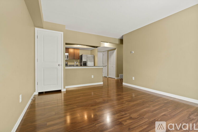 A room with wooden floors and a white door.