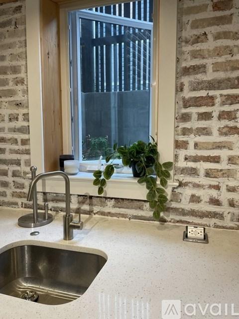 A kitchen sink with a window above it.
