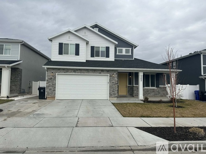 A two-story house with a garage is available for sale.