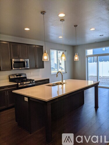 A kitchen with dark brown cabinets and a white countertop.