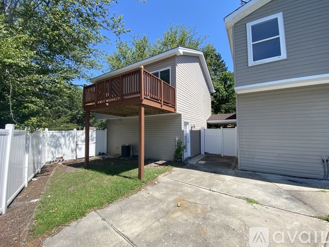 A house with a deck and a fence.