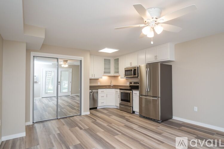 A kitchen with a refrigerator, oven, and microwave.