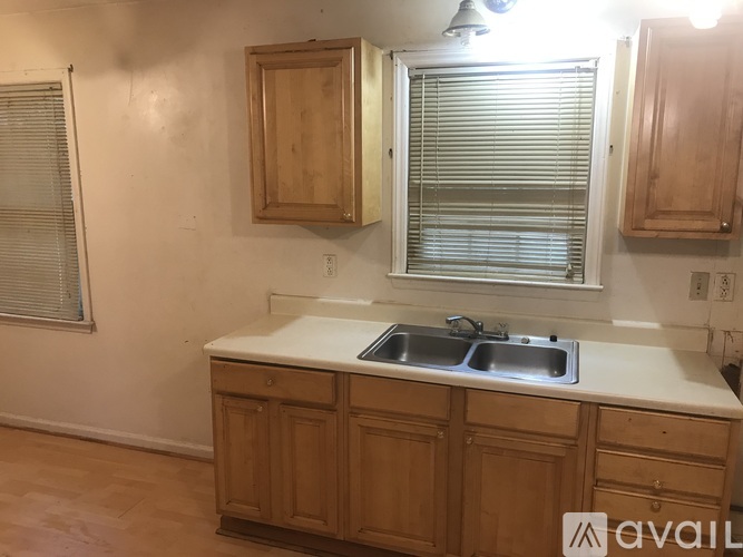 A kitchen with wooden cabinets and a white countertop.