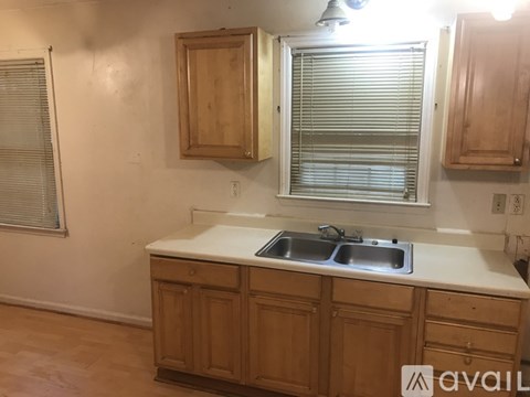 A kitchen with wooden cabinets and a white countertop.