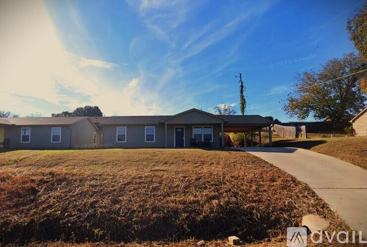 A sunny day at a residential area with houses and a clear sky.