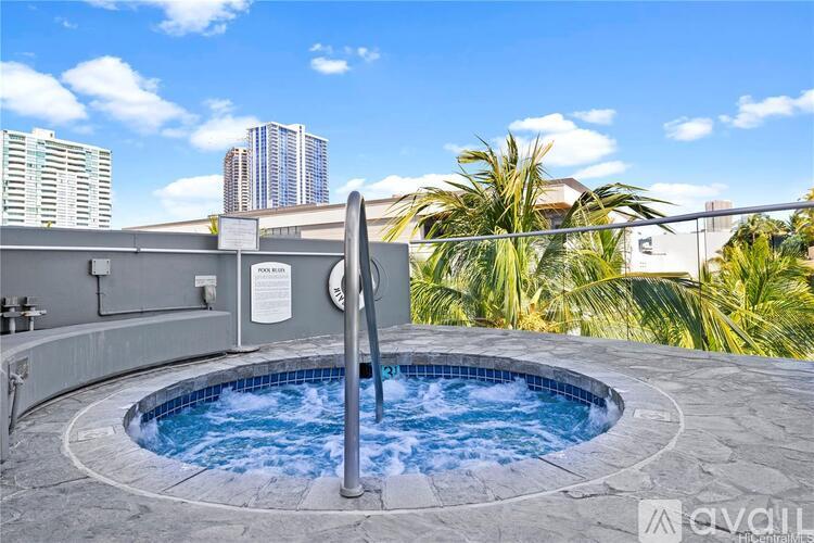A hot tub on a balcony with a city view in the background.