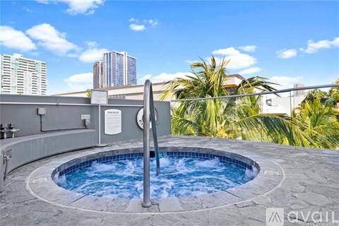 A hot tub on a balcony with a city view in the background.