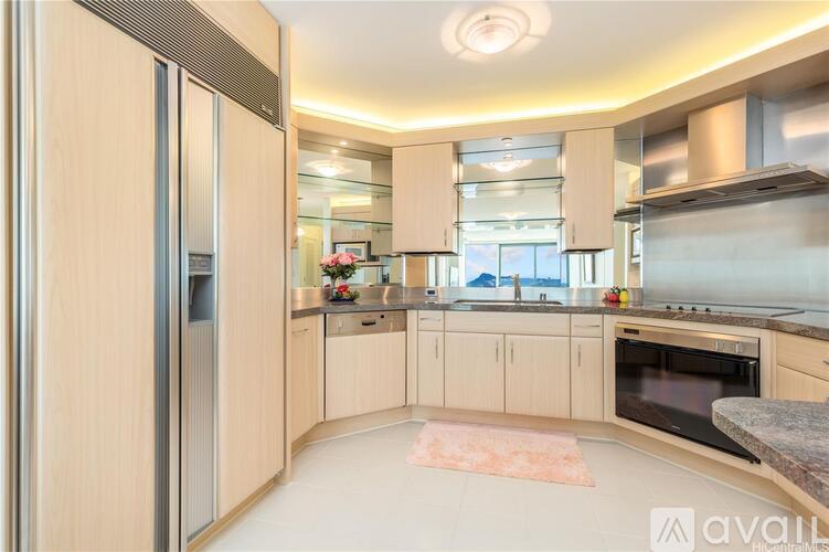 A kitchen with wooden cabinets and a refrigerator.