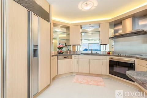 A kitchen with wooden cabinets and a refrigerator.