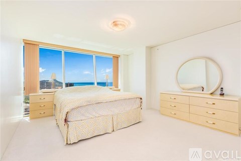 A bedroom with a large bed and a dresser with a mirror.