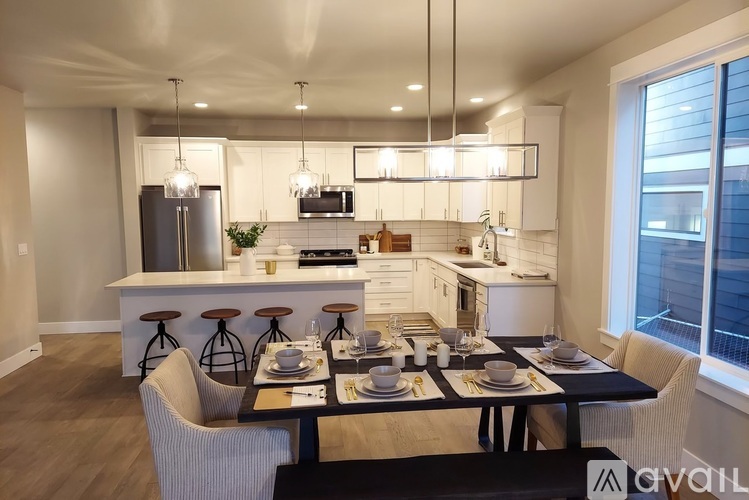 A modern kitchen with a dining table set for four.
