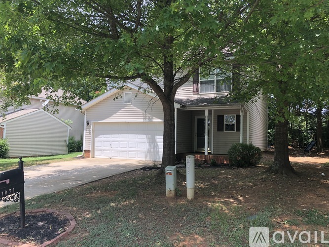A house with a tree in front of it.