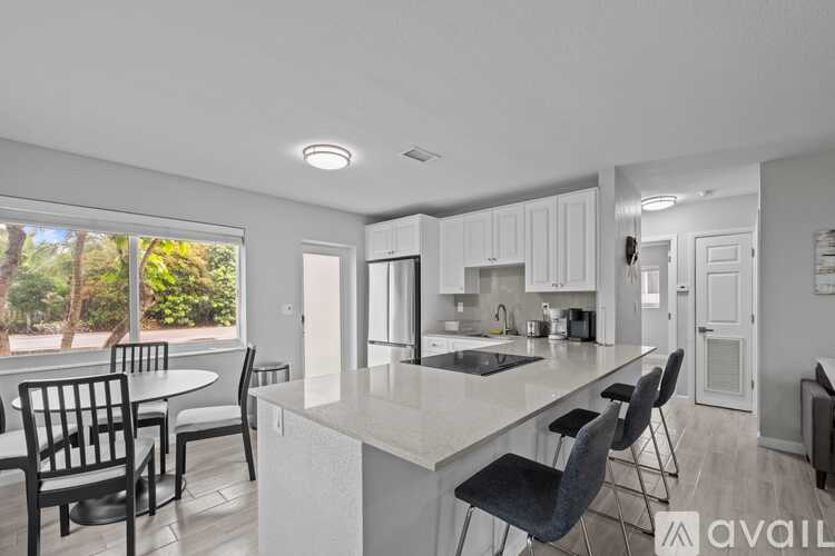 A kitchen with a table and chairs is available for rent.