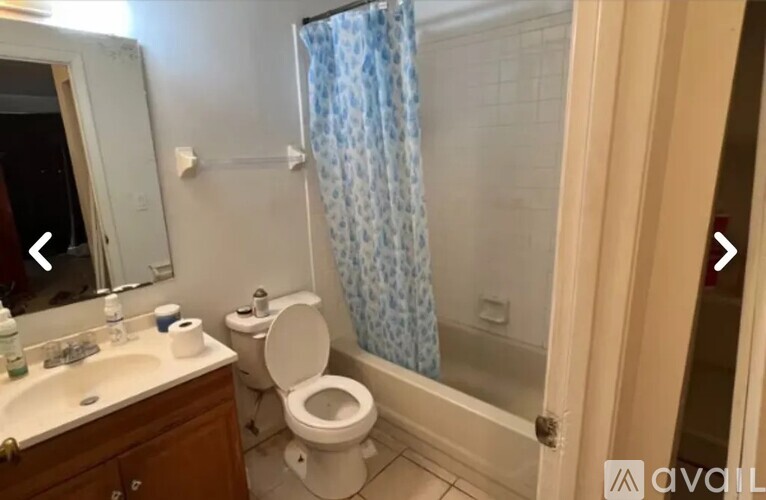 A bathroom with a toilet, sink, and shower.