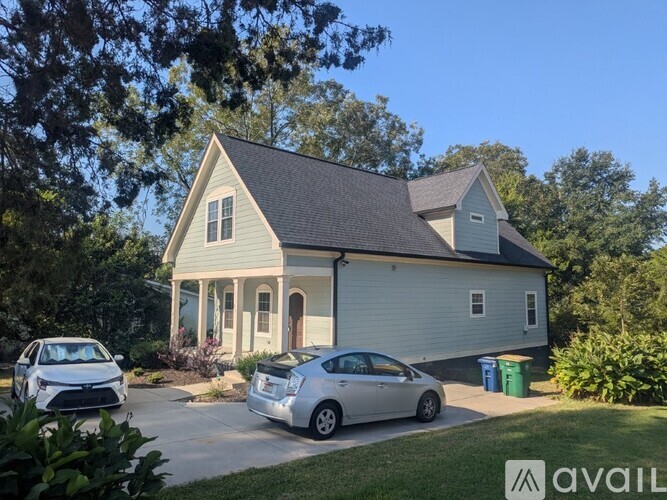 A house with a car parked in front of it.