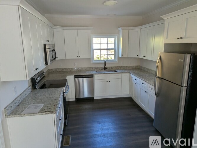 A kitchen with white cabinets and stainless steel appliances.