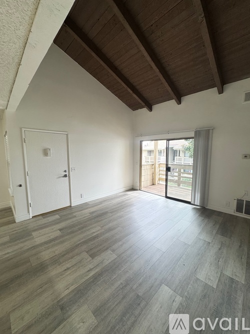 A room with wooden floors and a slanted ceiling.