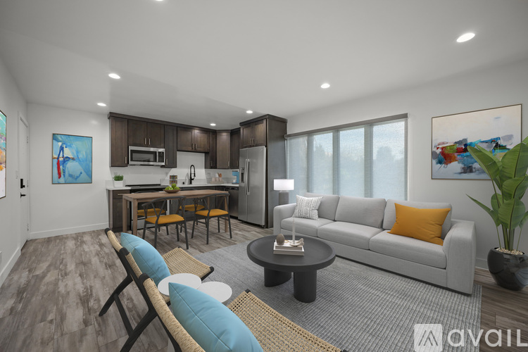 A modern living room with a grey sofa, a wooden chair, and a coffee table.