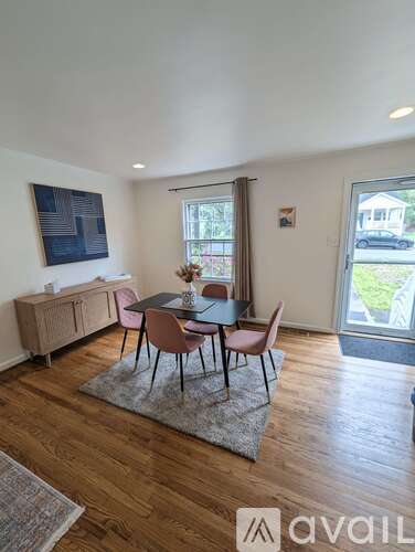 A dining room with a table set for four.