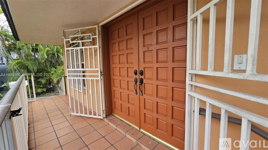 A brown door with a black handle is on the right side of the image.