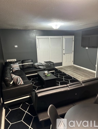 A living room with a black and white color scheme.