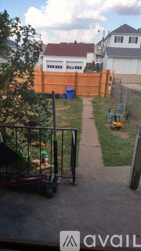 A backyard with a slide and a trampoline.