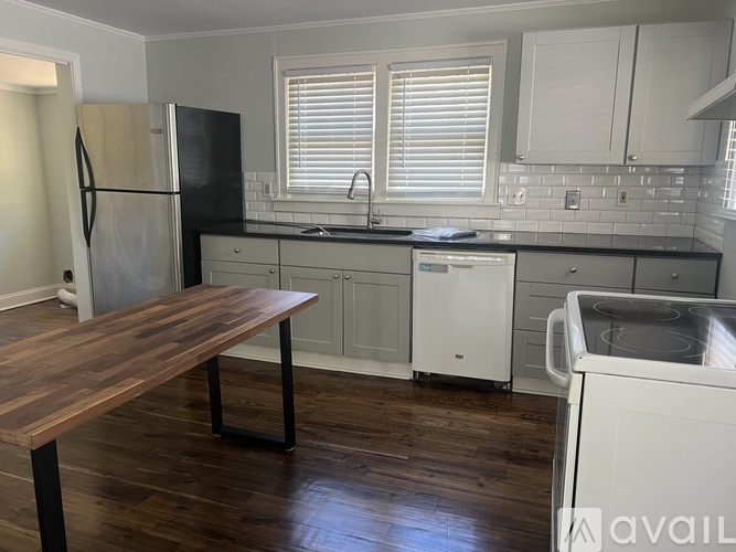A kitchen with a wooden table and white appliances.